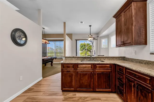 a kitchen with a stove a sink and a wooden cabinets