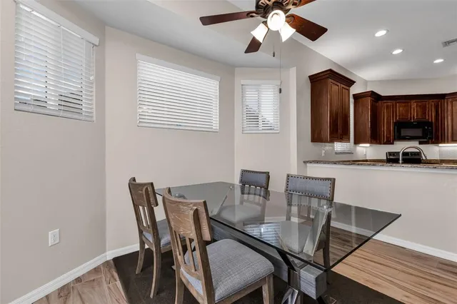 a view of a dining room with furniture and wooden floor