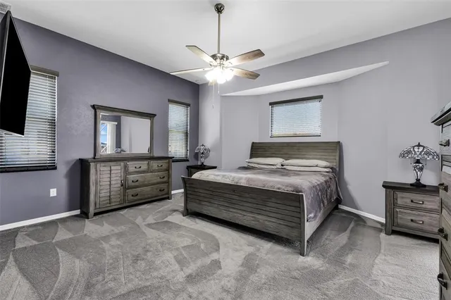 a bedroom with a bed dresser and a flat tv screen