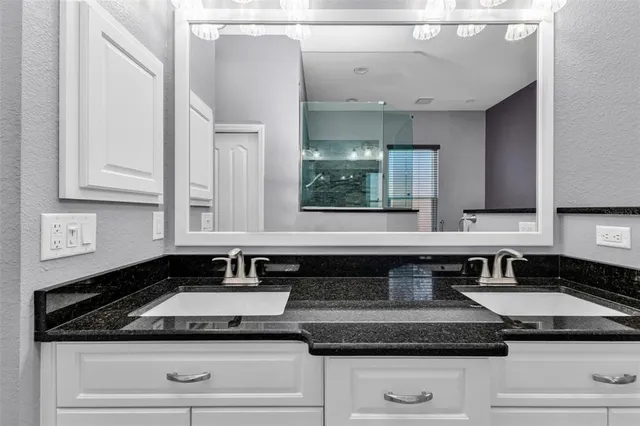 a kitchen with granite countertop a sink and cabinets
