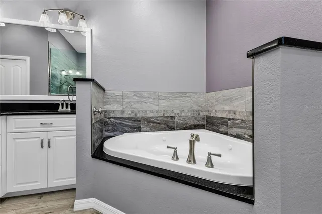 a bathroom with a bathtub and a sink