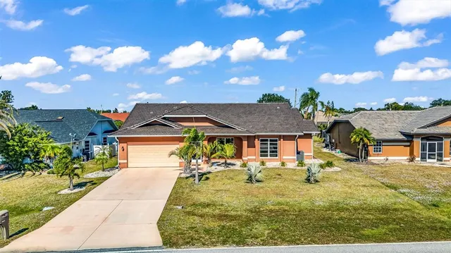 a front view of house with a garden