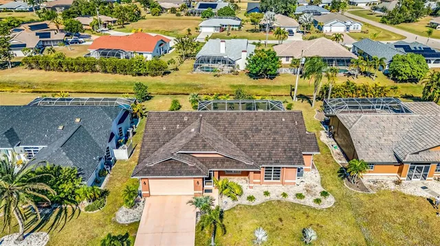 an aerial view of residential houses with outdoor space and swimming pool