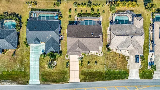 an aerial view of residential houses with outdoor space
