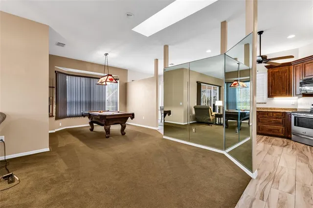 a view of a livingroom with wooden floor and furniture