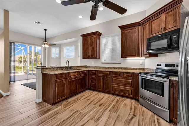 a kitchen with stainless steel appliances granite countertop a stove and cabinets