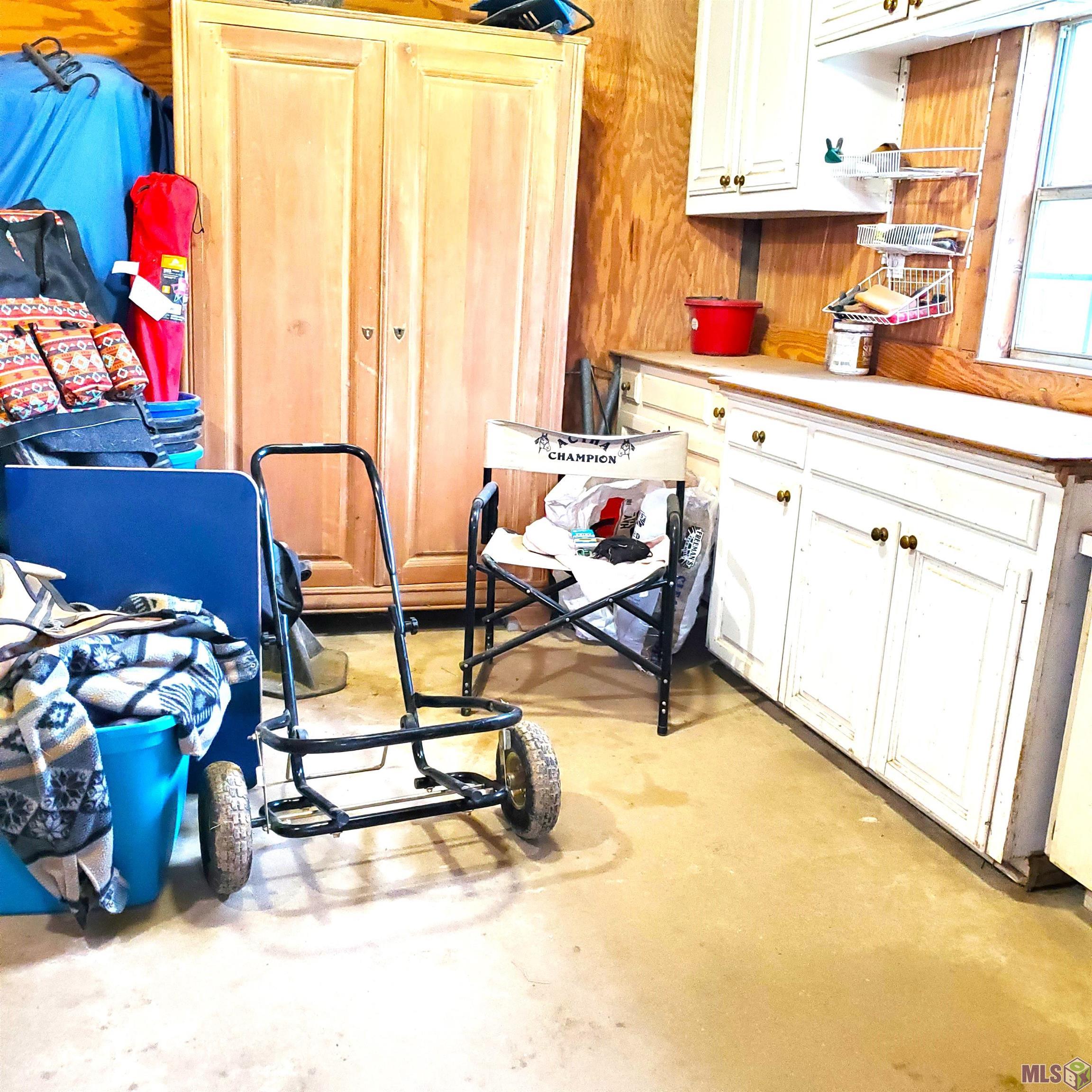 28243 Greenwell Springs Road Greenwell Springs, LA 70739 - Photo 31 of 40 Tackroom/ Concrete Floor