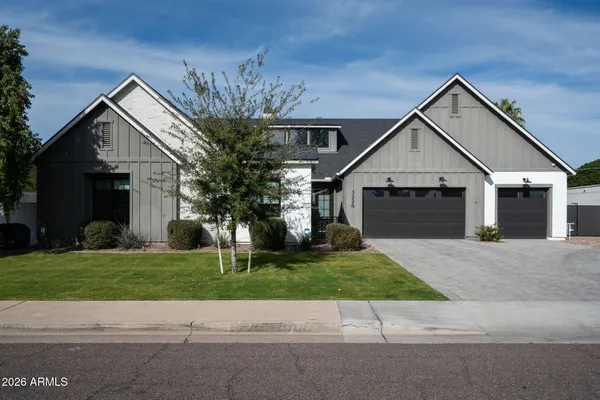 a front view of a house with a garden and yard