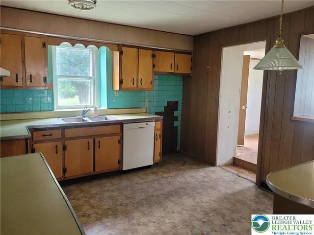 a kitchen with a sink stove and refrigerator