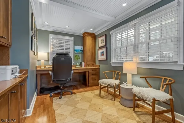 a view of a workspace with furniture and a window