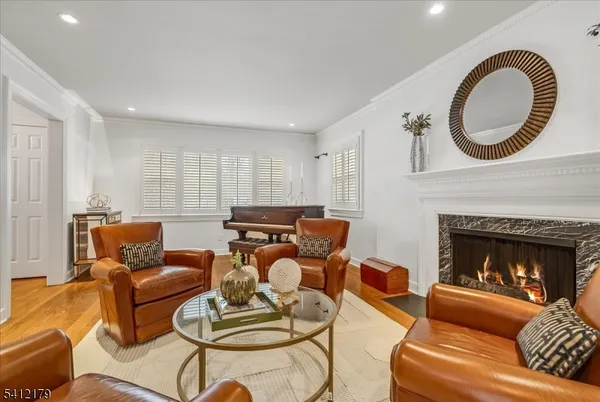 a living room with furniture a fireplace and a large window