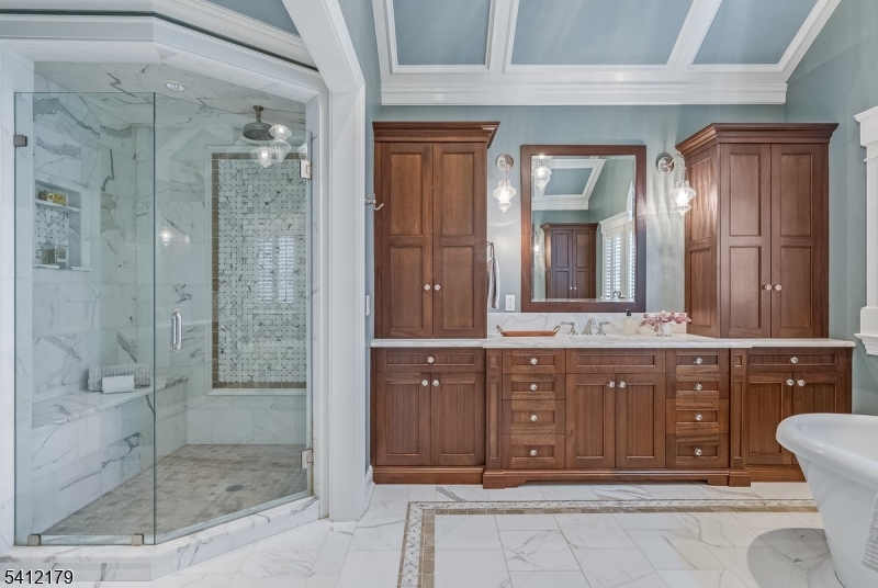 49 Hilltop Road Short Hills, NJ 07078 - Photo 22 of 34 a bathroom with a granite countertop sink a mirror and shower