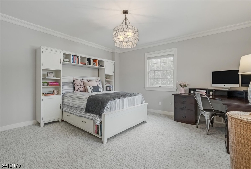 49 Hilltop Road Short Hills, NJ 07078 - Photo 23 of 34 a bedroom with a bed and a tv in it