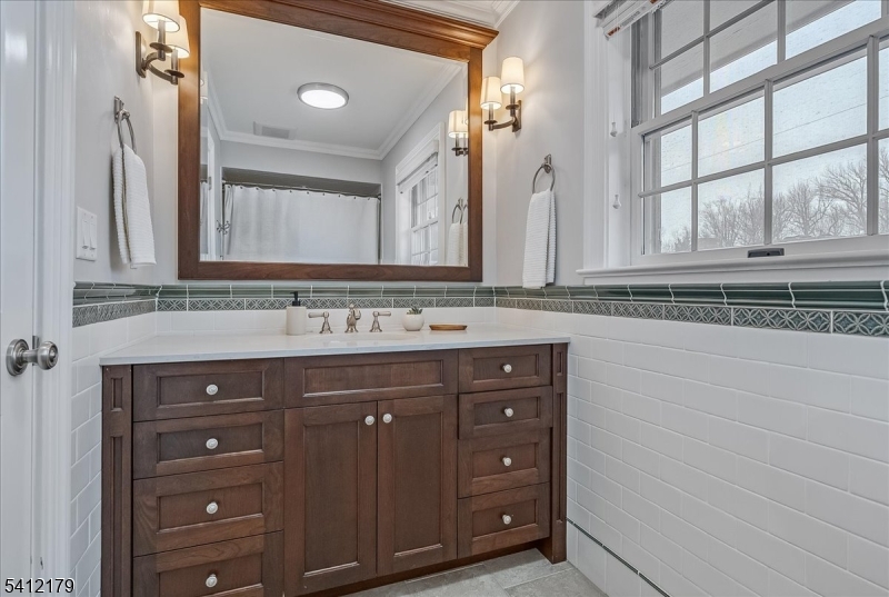 49 Hilltop Road Short Hills, NJ 07078 - Photo 24 of 34 a bathroom with a sink and a mirror