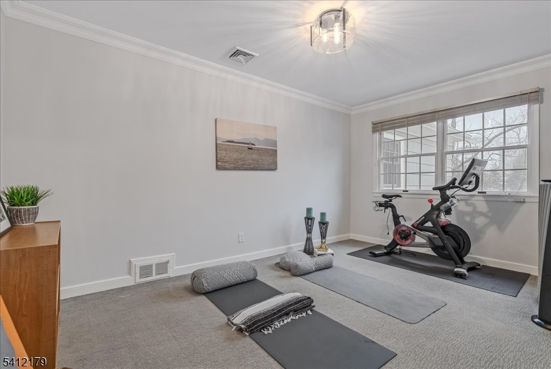 49 Hilltop Road Short Hills, NJ 07078 - Photo 26 of 34 a room with gym equipment and a large window