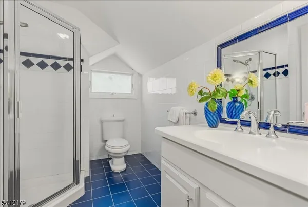 a bathroom with a sink a toilet and a shower