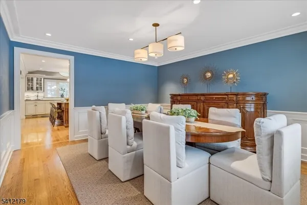 a dining room with furniture and wooden floor