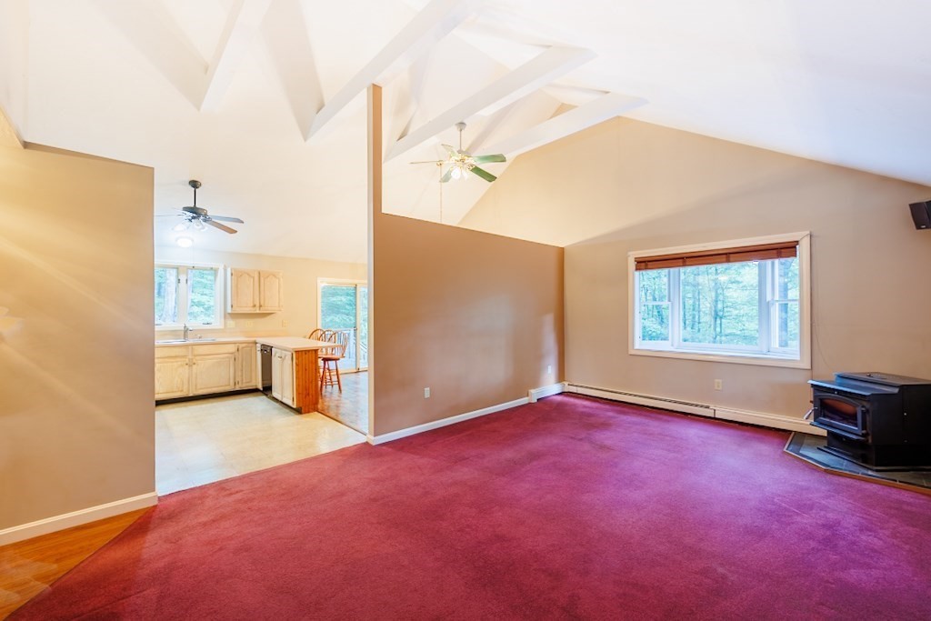 571 Douglas Road Northbridge, MA 01588 - Photo 11 of 29 a view of a big room with windows and chandelier fan
