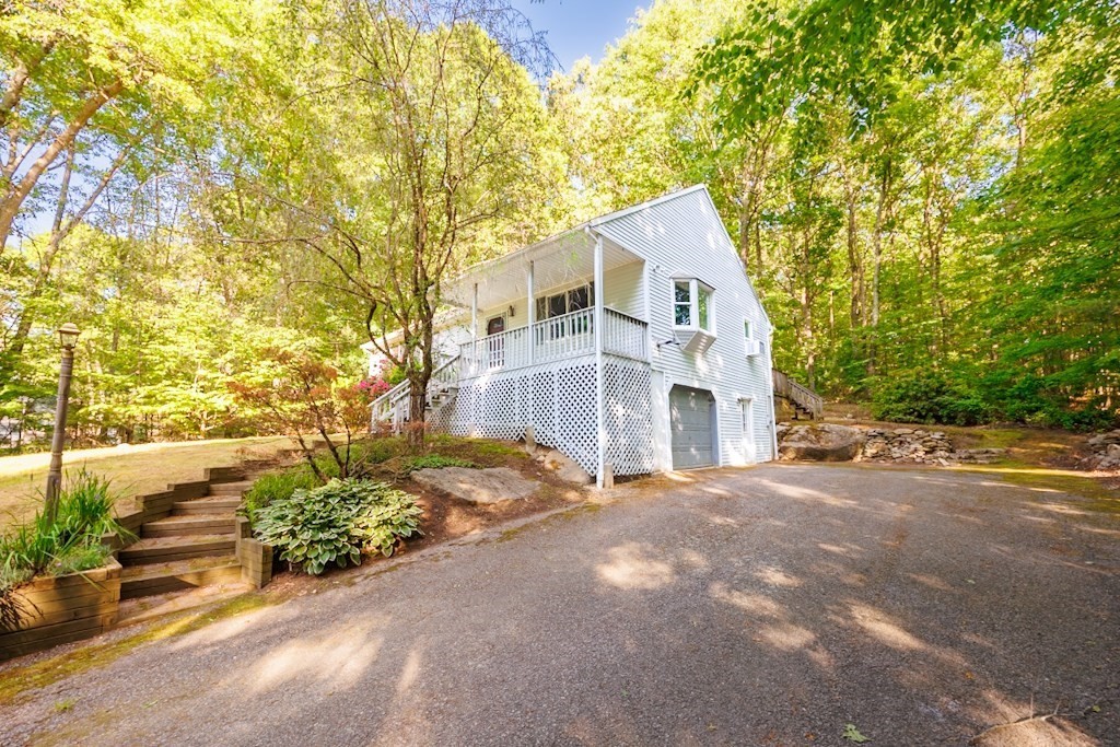 571 Douglas Road Northbridge, MA 01588 - Photo 27 of 29 a front view of a house with a yard and garage