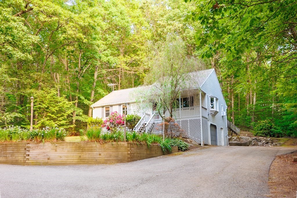 571 Douglas Road Northbridge, MA 01588 - Photo 3 of 29 front view of a house with a yard and potted plants