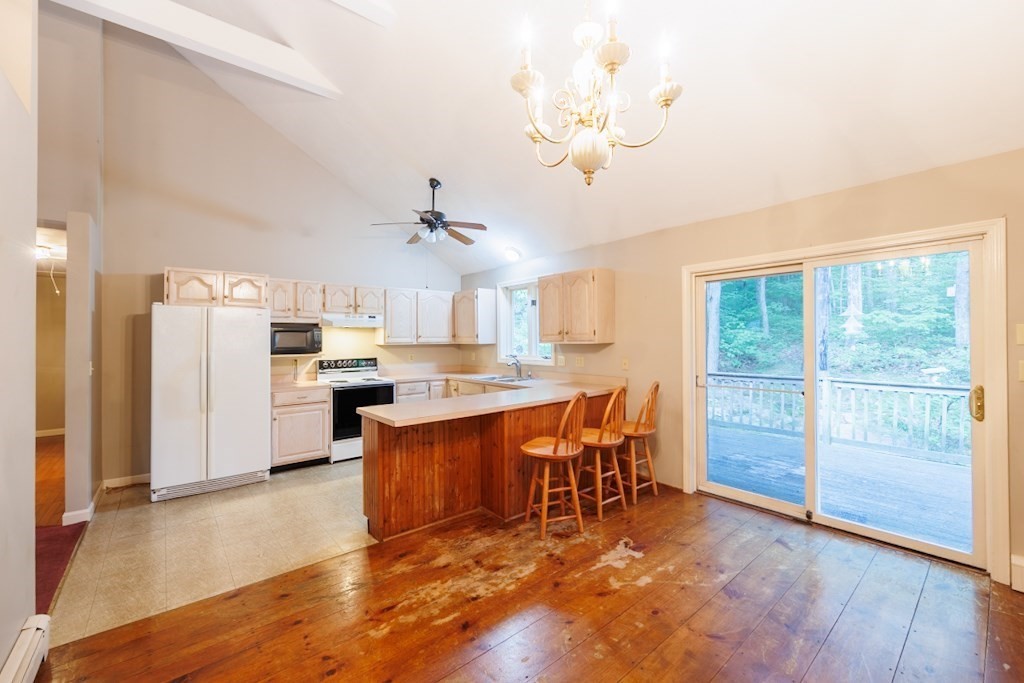 571 Douglas Road Northbridge, MA 01588 - Photo 8 of 29 a view of kitchen with furniture and wooden floor