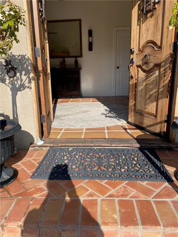 a view of a balcony with two chairs and a table