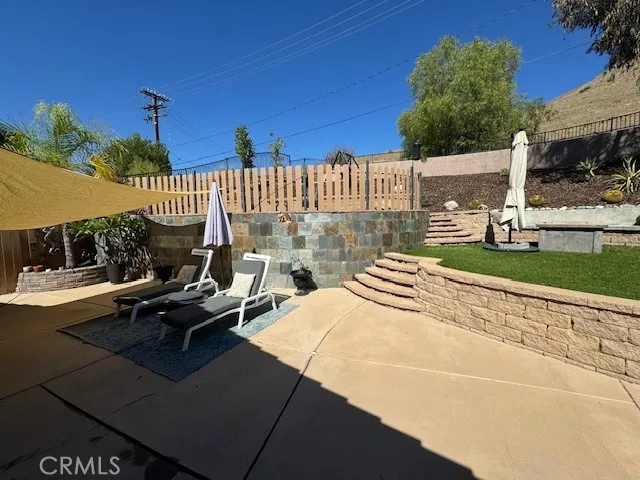 a view of a patio with a table and chairs