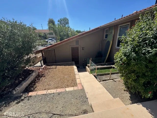 a view of backyard with wooden fence and potted plants