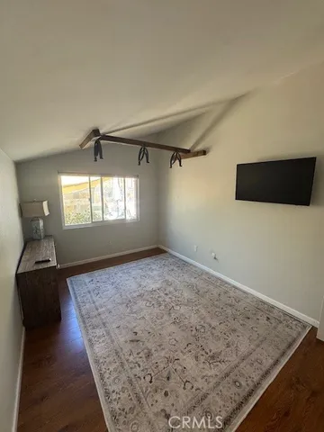 a view of a livingroom with wooden floor and window