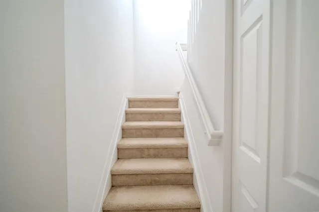 a view of staircase with white walls