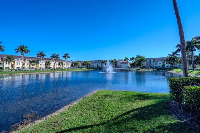 a view of a lake with boats and trees in the background
