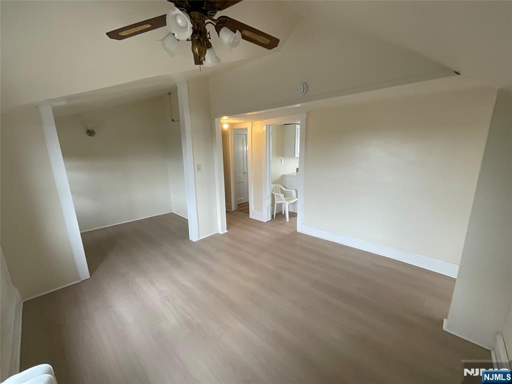 131 Delafield Avenue, Unit 3 Lyndhurst, NJ 07071 - Photo 3 of 15 an empty room with wooden floor and windows
