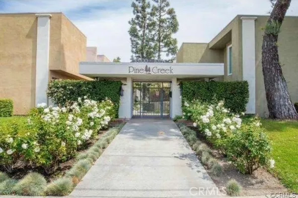 a front view of a house having a garden