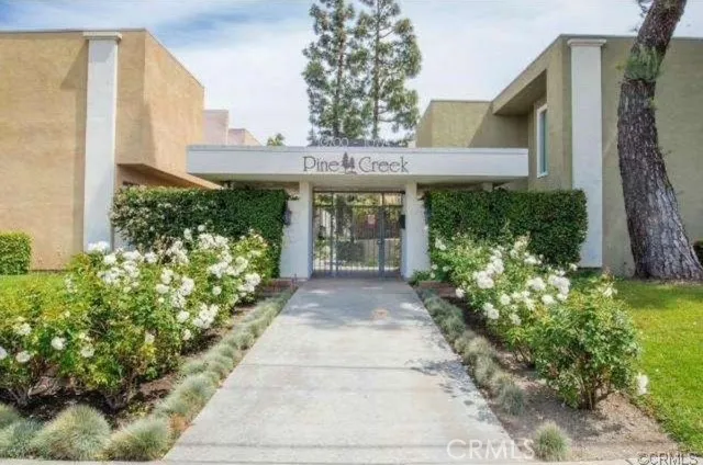 a front view of a house having a garden