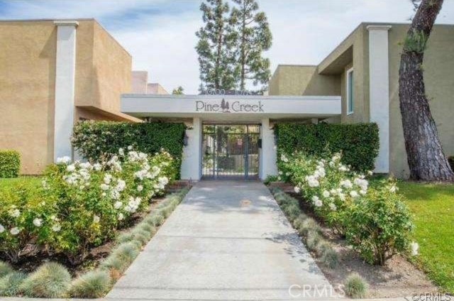 a front view of a house having a garden