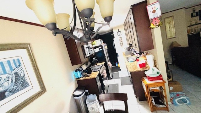 10700 Knott Avenue Stanton, CA 90680 - Photo 3 of 7 a living room with furniture and a flat screen tv