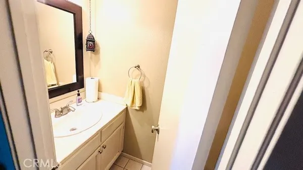 a bathroom with a sink vanity and a mirror