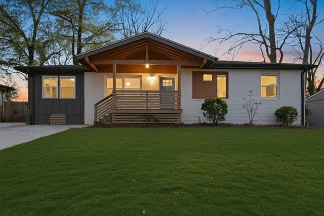 a front view of a house with a garden