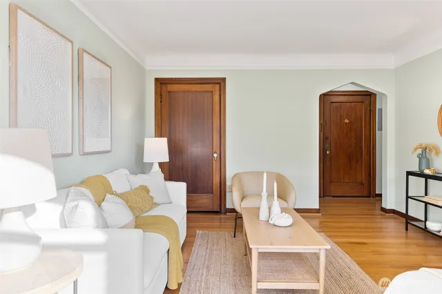 a view of a bedroom with furniture and wooden floor