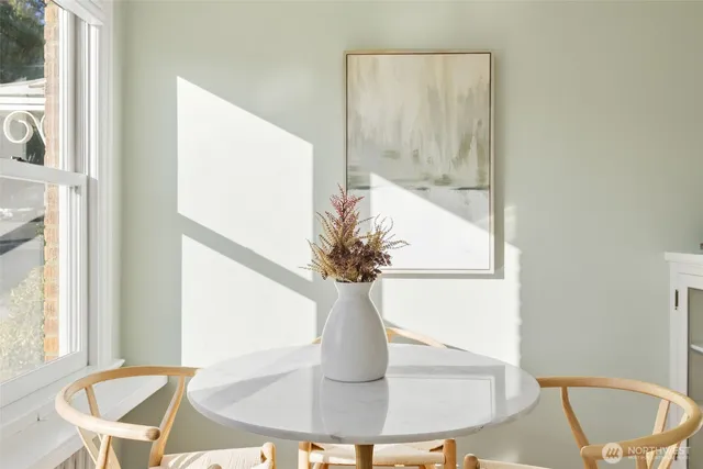 a view of a dining room with furniture and a window