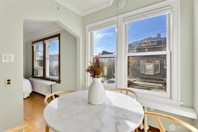 a view of a living room with furniture and floor to ceiling window