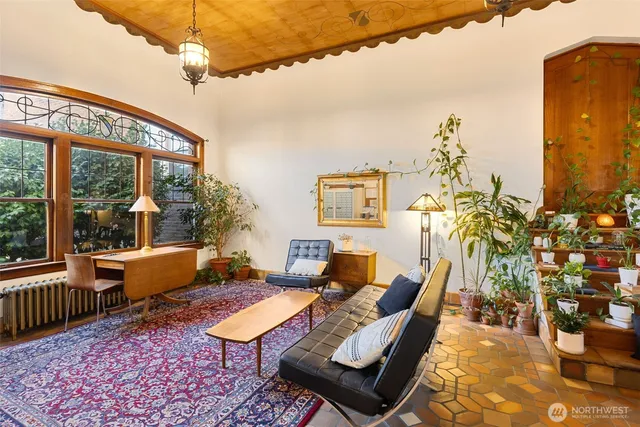 a living room with furniture and flowers