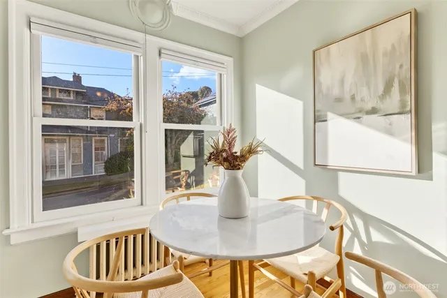 a dining room with a glass top table and chairs