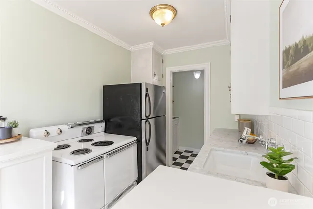 a kitchen with a sink a refrigerator and a stove