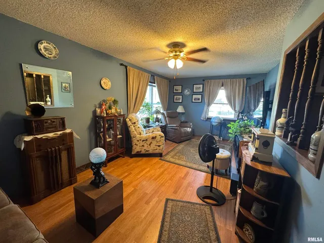 a living room with furniture a chandelier and a flat screen tv