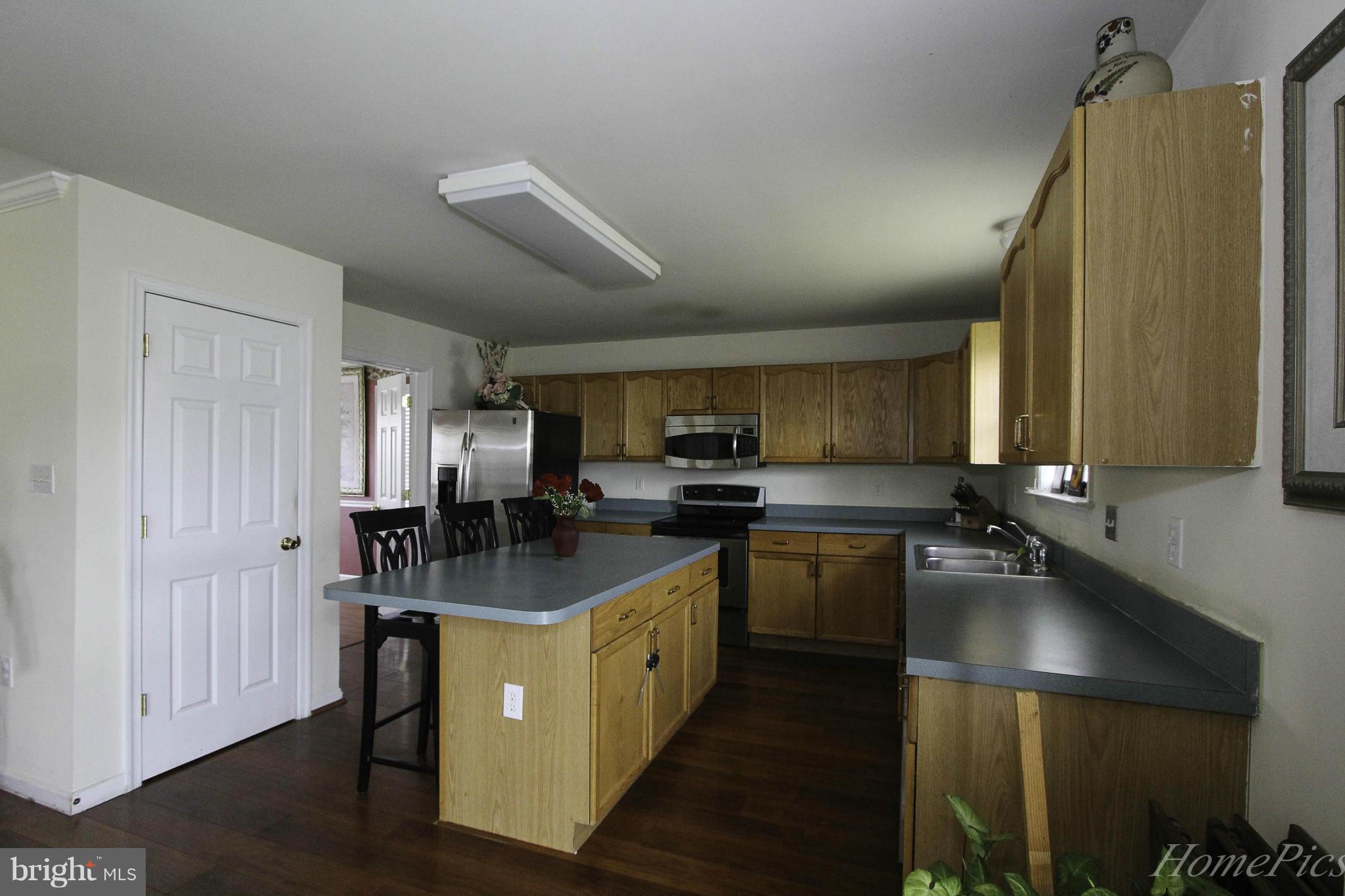 109 Limited Drive Ranson, WV 25438 - Photo 12 of 29 a kitchen with kitchen island granite countertop a sink counter top space and stainless steel appliances