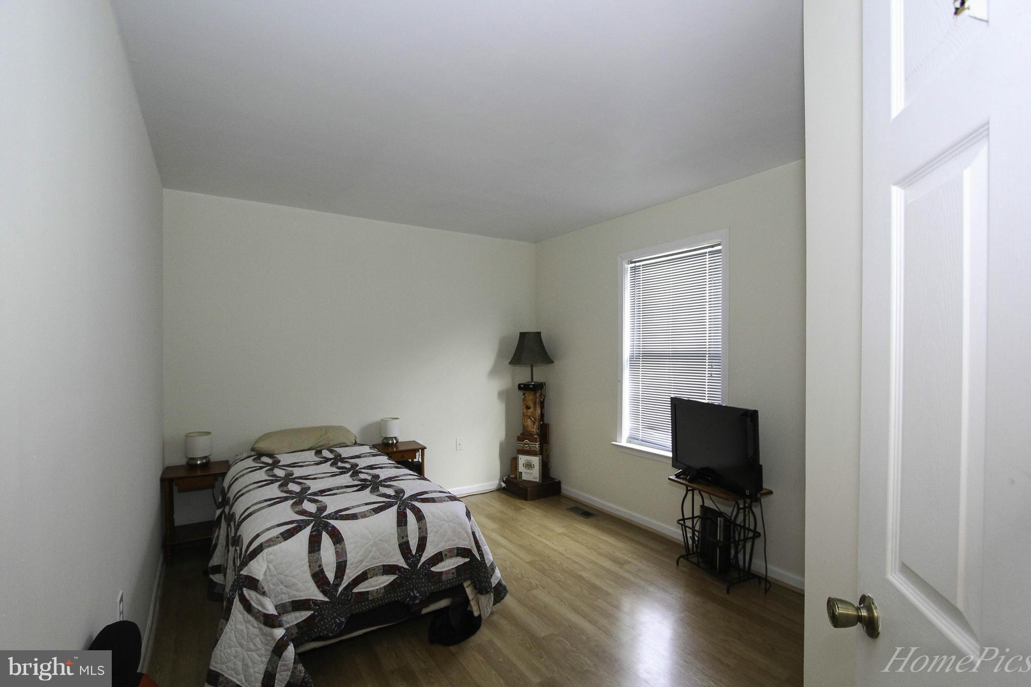109 Limited Drive Ranson, WV 25438 - Photo 18 of 29 a bedroom with a bed and a tv on the table