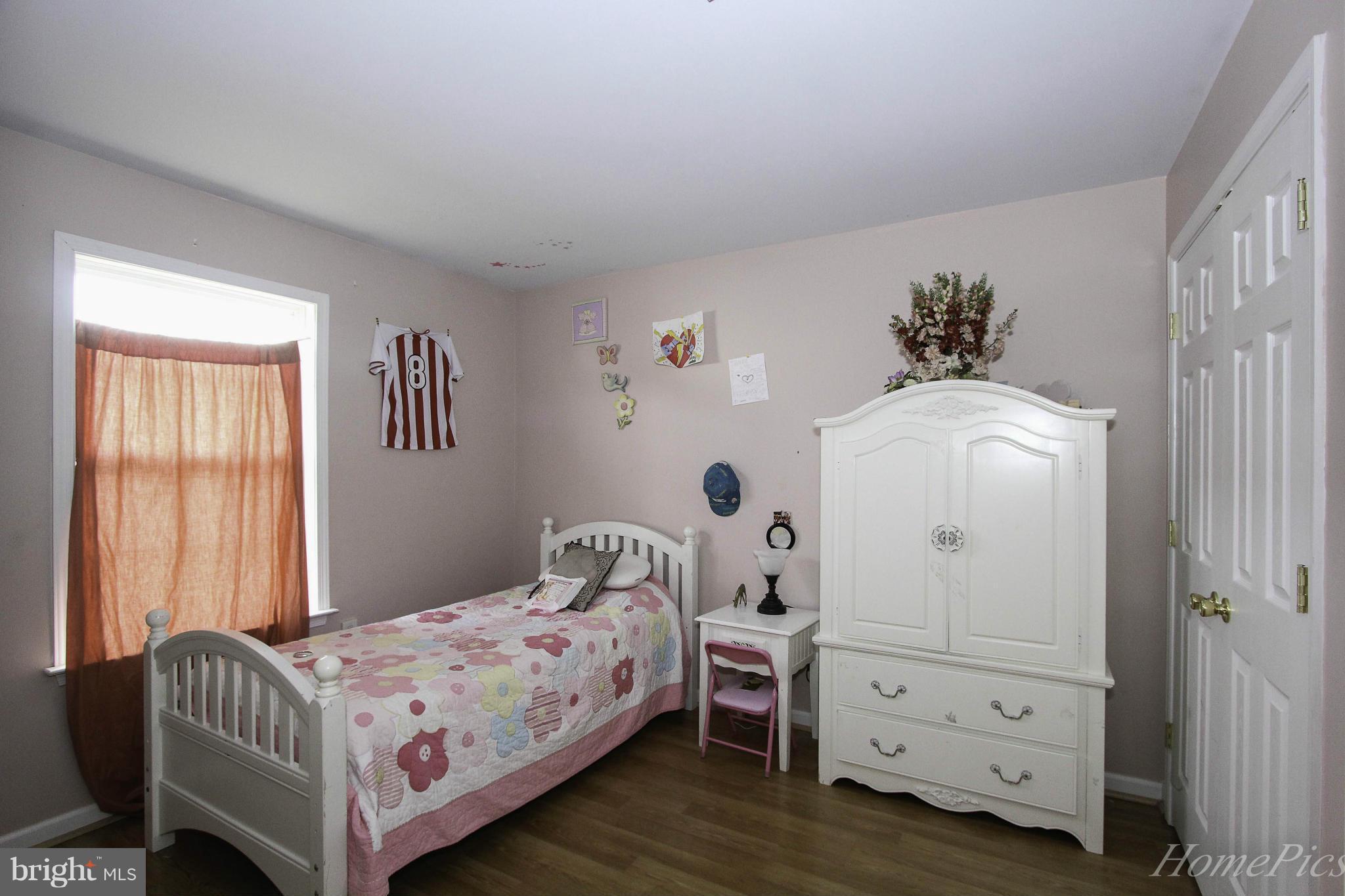 109 Limited Drive Ranson, WV 25438 - Photo 19 of 29 a bedroom with a bed and a window