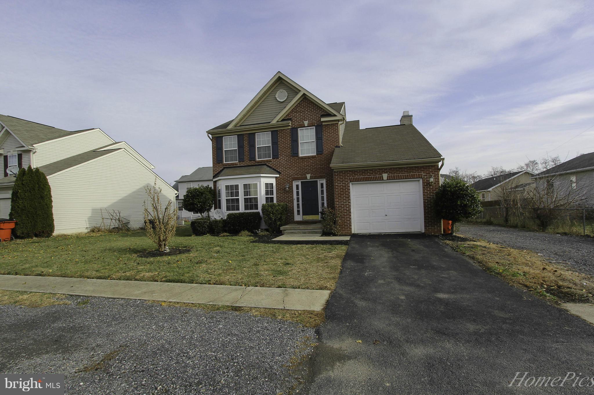 109 Limited Drive Ranson, WV 25438 - Photo 23 of 29 a front view of a house with a yard