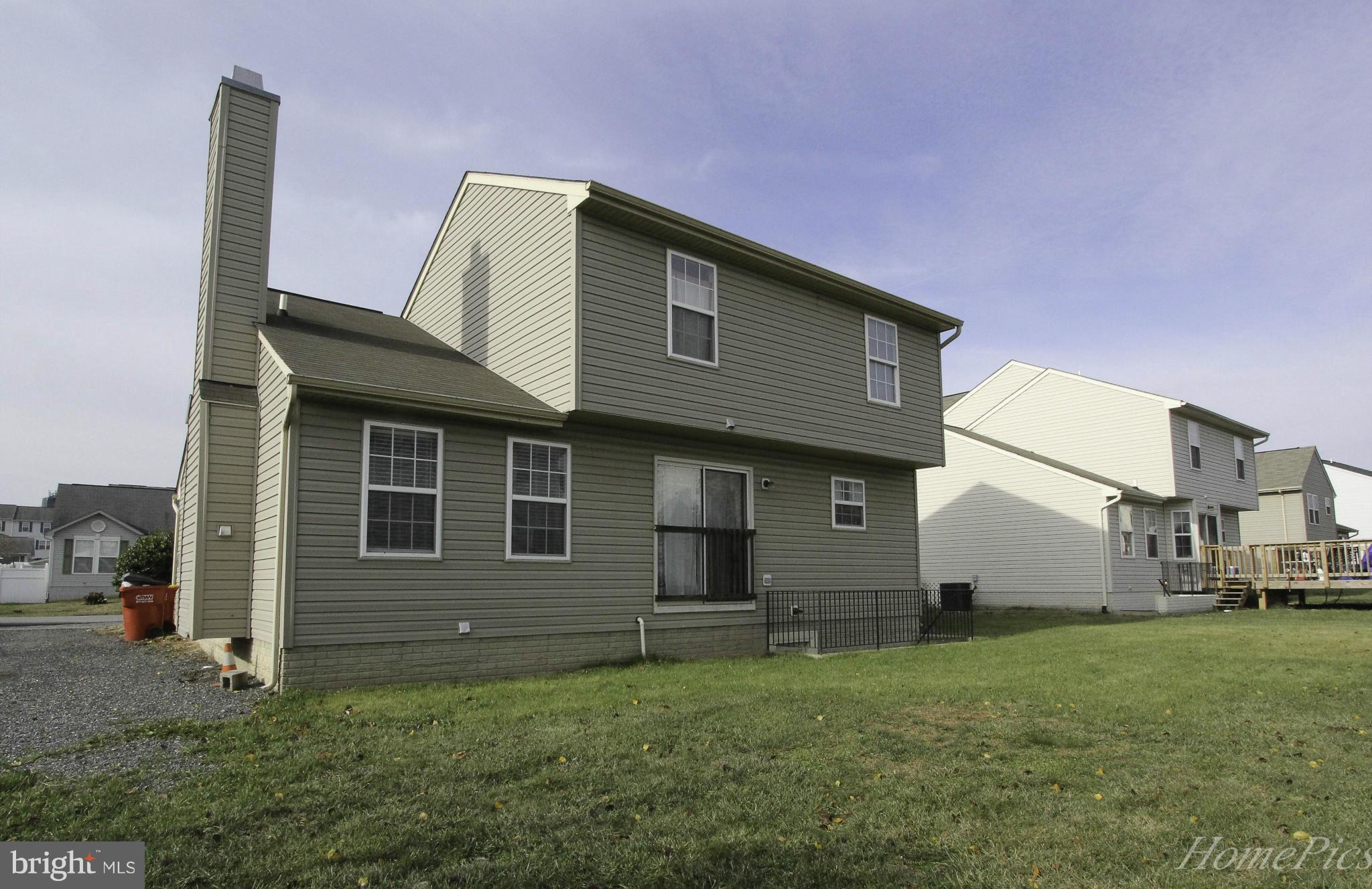109 Limited Drive Ranson, WV 25438 - Photo 24 of 29 a front view of a house with a garden